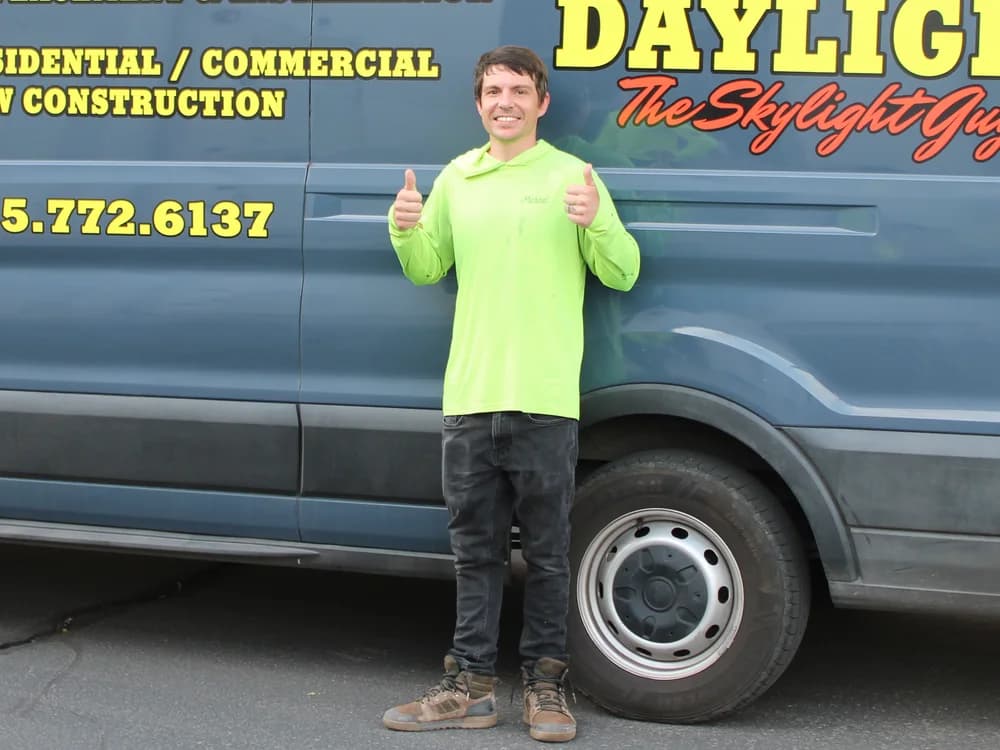 Michael Wall, COO and co-founder of Desert Sky Daylight, beside the company van in Washington, Utah
