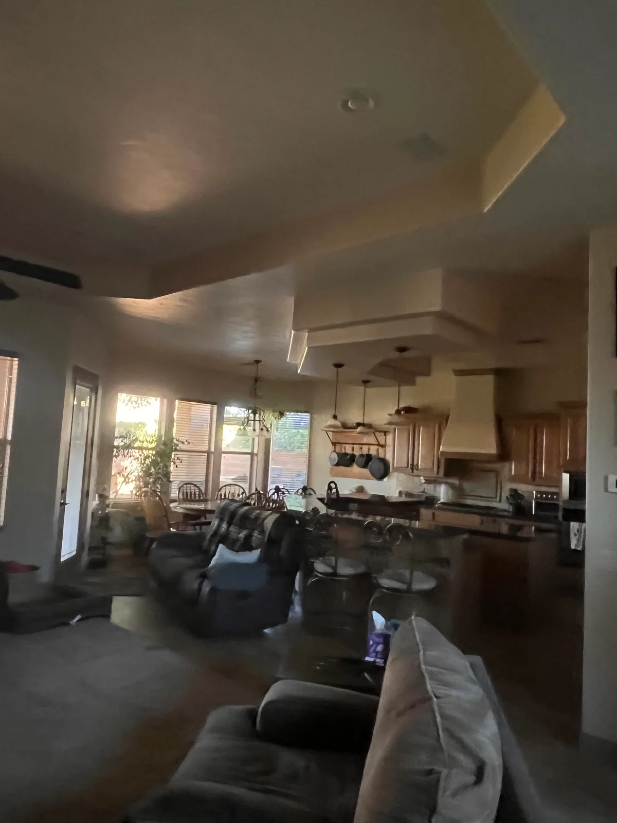 Living room and kitchen dim in the afternoon before sun tunnels